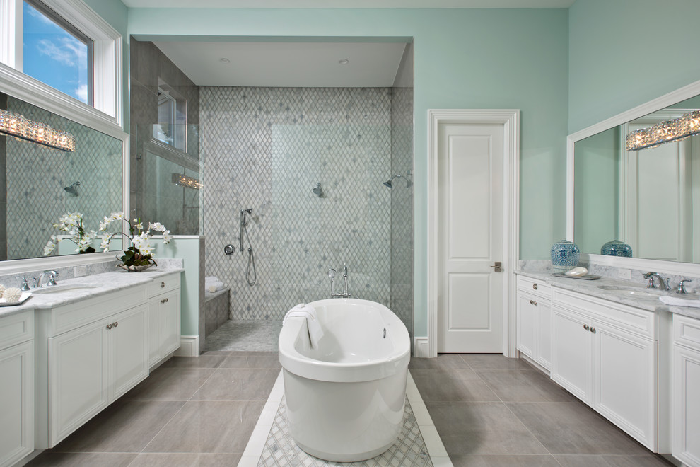 Design ideas for a large transitional master bathroom in Miami with recessed-panel cabinets, white cabinets, a freestanding tub, a double shower, gray tile, green walls, an open shower and grey benchtops.