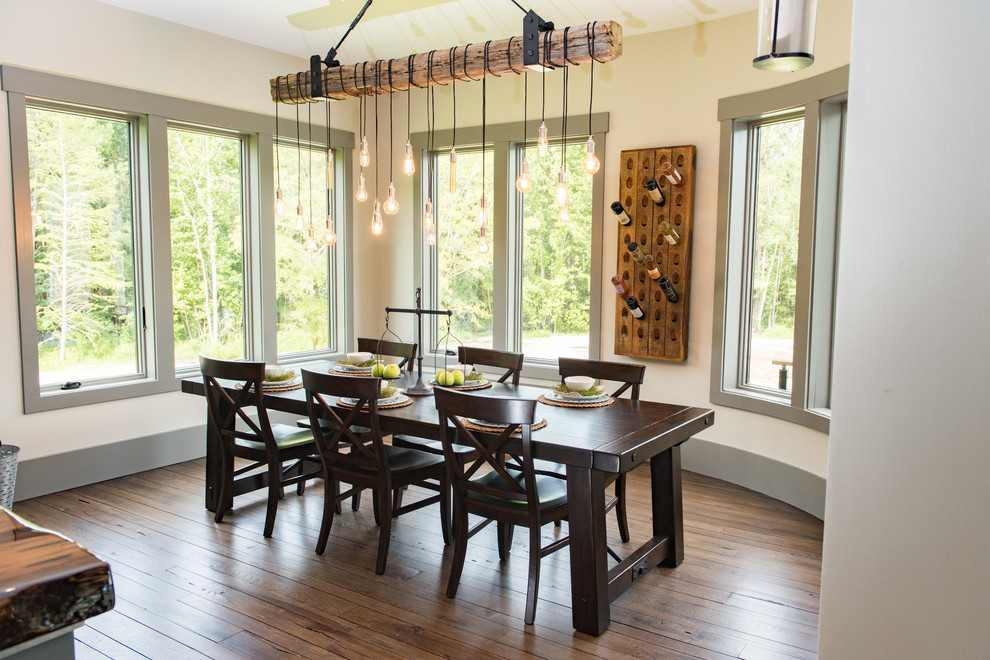 Inspiration for a mid-sized rustic dark wood floor and brown floor kitchen/dining room combo remodel in Charleston with beige walls and no fireplace