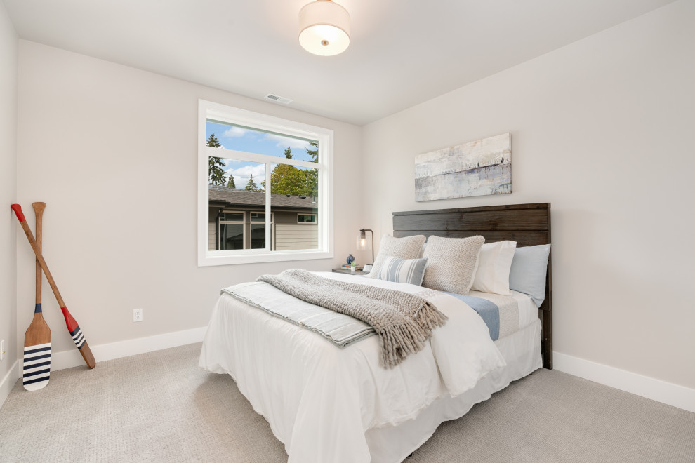 This is an example of a large country guest bedroom in Seattle with grey walls, carpet, no fireplace and beige floor.