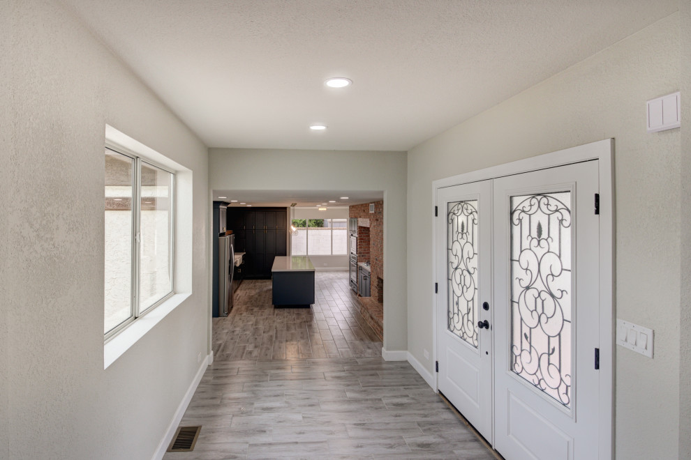 Mid-sized transitional porcelain tile and gray floor entryway photo in Phoenix