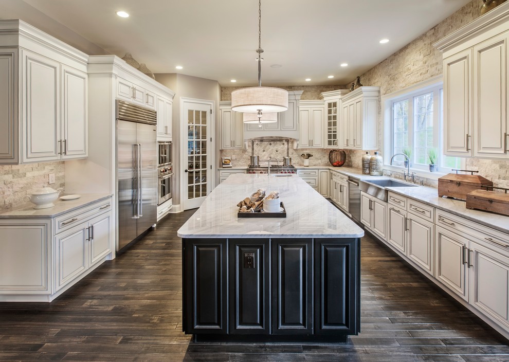 Design ideas for a traditional kitchen in Philadelphia with a farmhouse sink, raised-panel cabinets, white cabinets, beige splashback, stainless steel appliances, dark hardwood floors and with island.