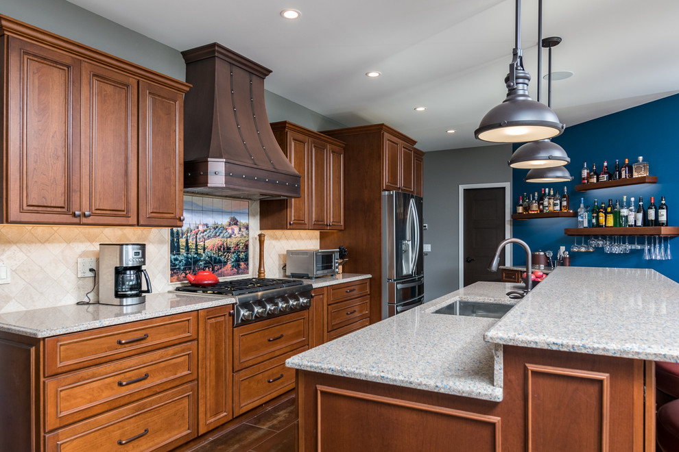 Mid-sized arts and crafts galley open plan kitchen in New York with an undermount sink, beaded inset cabinets, medium wood cabinets, granite benchtops, beige splashback, stone tile splashback, stainless steel appliances, cement tiles, with island and orange floor.