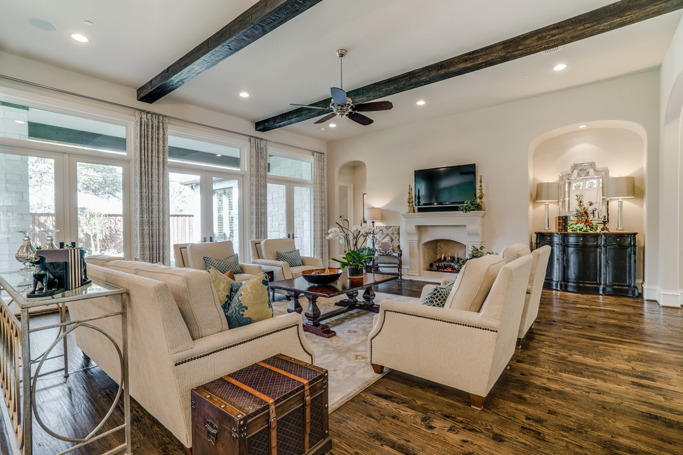 Large traditional formal open concept living room in Dallas with white walls, medium hardwood floors, a standard fireplace, a stone fireplace surround and a wall-mounted tv.
