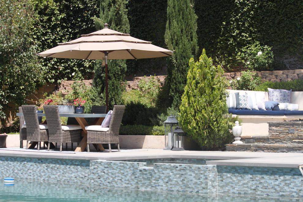Large transitional backyard concrete and rectangular pool photo in Los Angeles