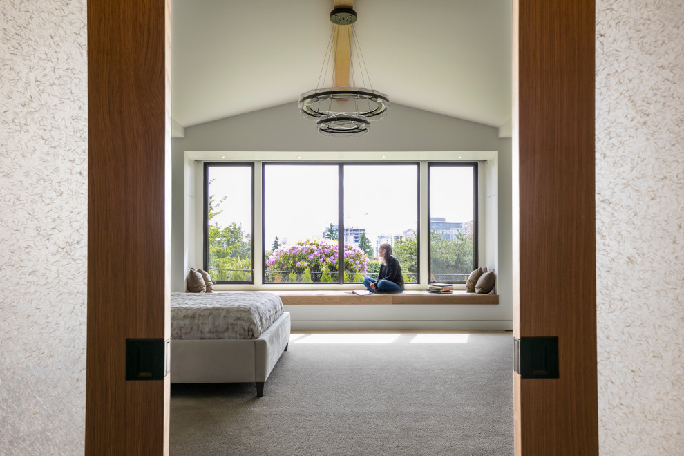Inspiration for a large transitional master bedroom in Seattle with white walls, carpet, grey floor and vaulted.