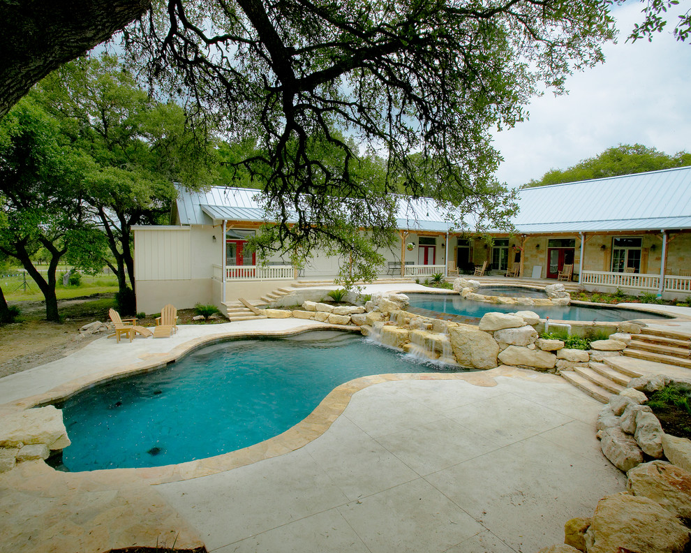 Large mountain style courtyard concrete and custom-shaped natural home design photo in Austin