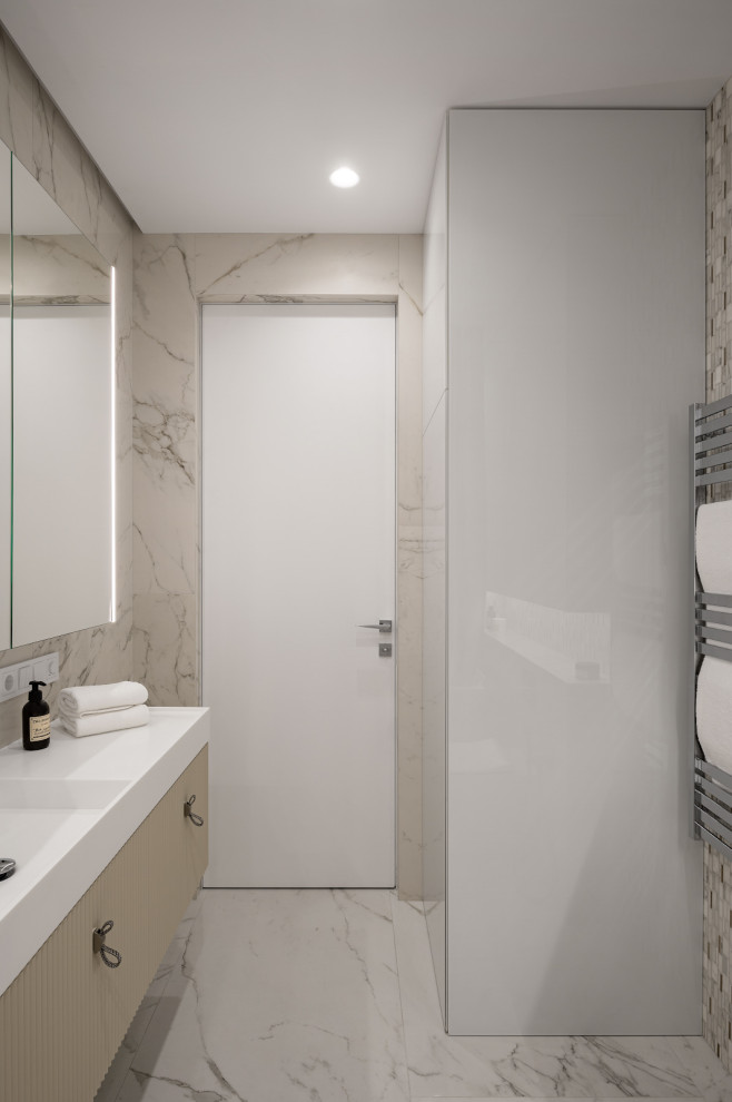 Inspiration for a mid-sized contemporary master bathroom in Moscow with flat-panel cabinets, beige cabinets, an alcove tub, a shower/bathtub combo, a wall-mount toilet, beige tile, ceramic tile, beige walls, porcelain floors, a wall-mount sink, beige floor, a shower curtain, white benchtops, a laundry, a single vanity and a floating vanity.