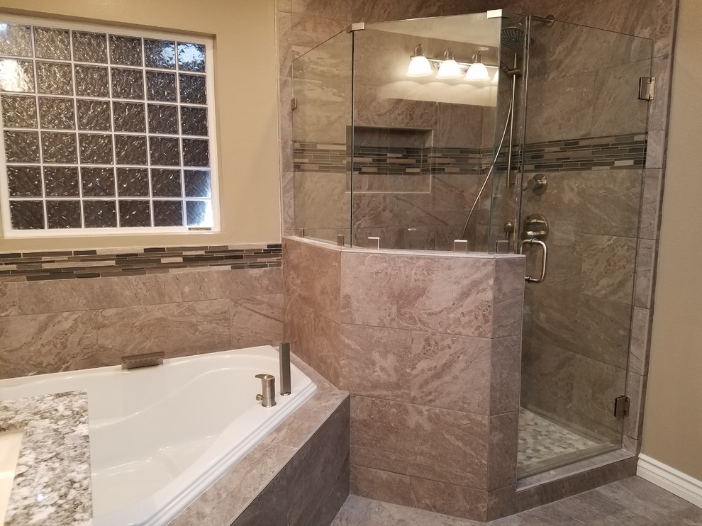 Mid-sized traditional master bathroom in Los Angeles with a hot tub, a corner shower, beige tile, porcelain tile, porcelain floors, beige floor and a hinged shower door.