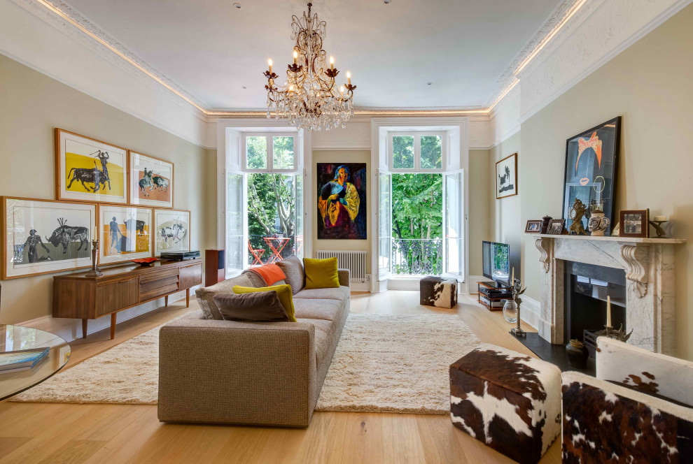 This is an example of a mid-sized transitional formal enclosed living room in London with green walls, light hardwood floors, a standard fireplace, a stone fireplace surround, a built-in media wall and coffered.