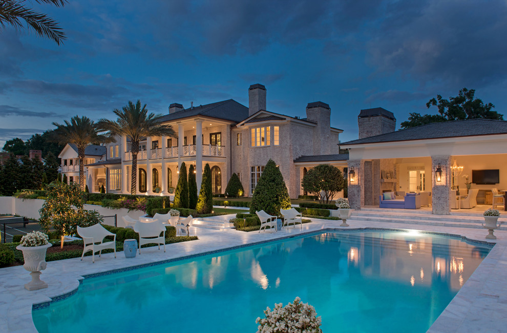 Inspiration for a huge timeless backyard stone and custom-shaped lap pool remodel in Orlando