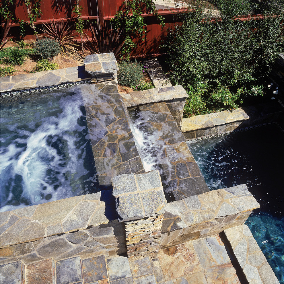 Transitional backyard stone and rectangular pool fountain photo in Orange County