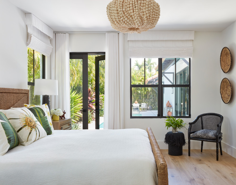Design ideas for a mid-sized transitional master bedroom in Miami with white walls and light hardwood floors.