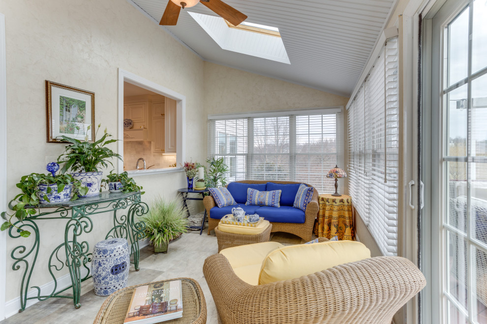 This is an example of a medium sized classic conservatory in DC Metro with vinyl flooring, a skylight and grey floors.