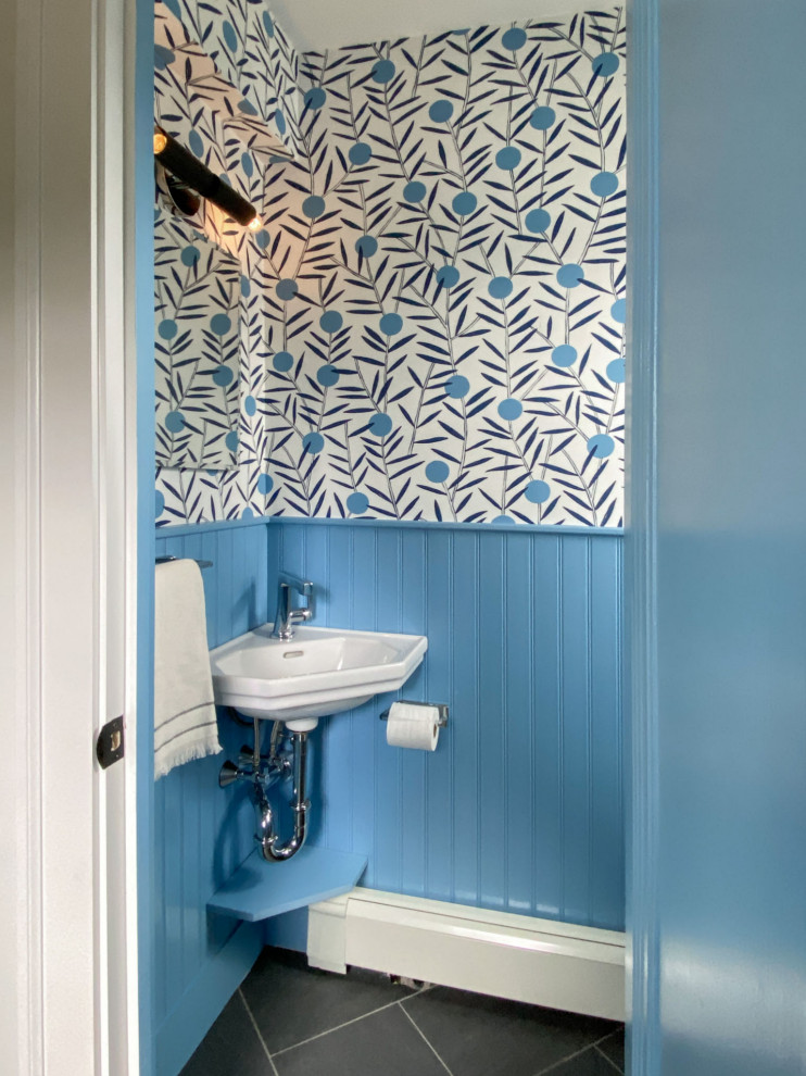 Design ideas for a midcentury cloakroom in Boston with blue walls, black floors and wallpapered walls.