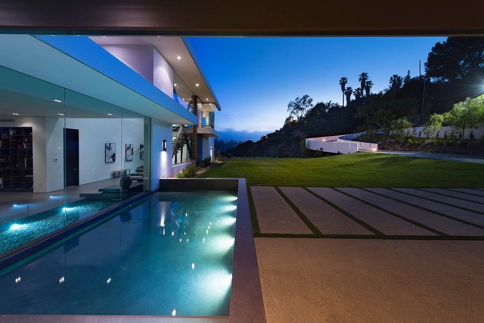 This is an example of a small modern front rectangular above ground swimming pool in Los Angeles with a water feature.