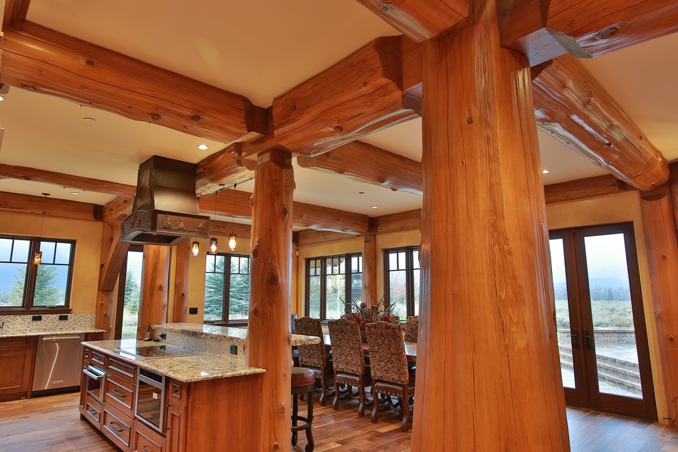 Eat-in kitchen - large rustic l-shaped eat-in kitchen idea with recessed-panel cabinets, medium tone wood cabinets, granite countertops, white backsplash, ceramic backsplash, stainless steel appliances and an island