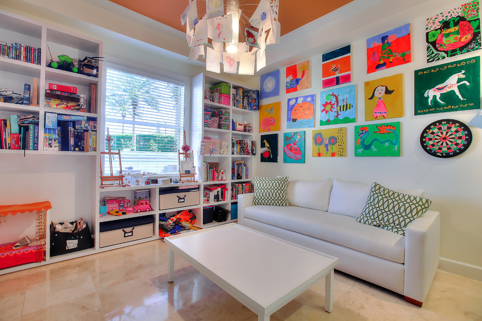 This is an example of a transitional gender-neutral kids' playroom for kids 4-10 years old in Miami with beige walls and beige floor.