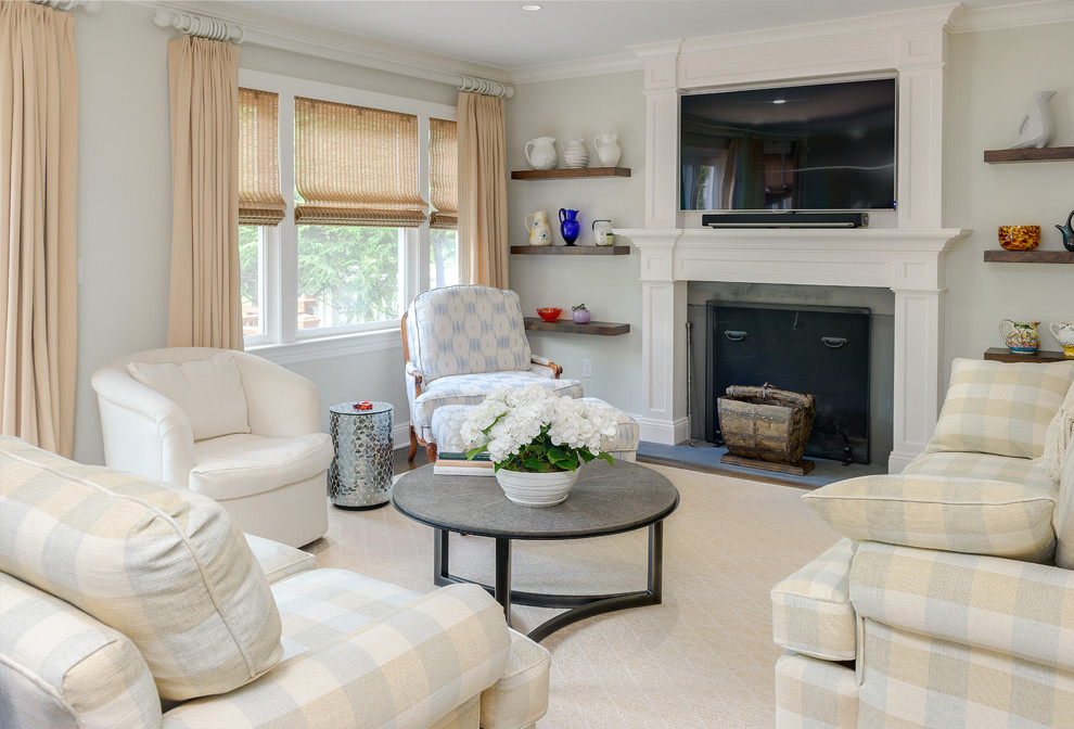 Mid-sized transitional enclosed family room in New York with grey walls, carpet, a standard fireplace, a wall-mounted tv and a wood fireplace surround.