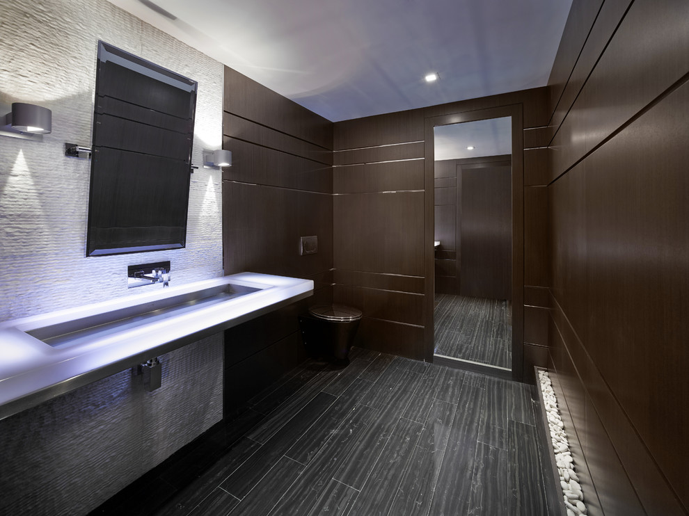 Photo of a contemporary powder room in Miami with a trough sink and a wall-mount toilet.