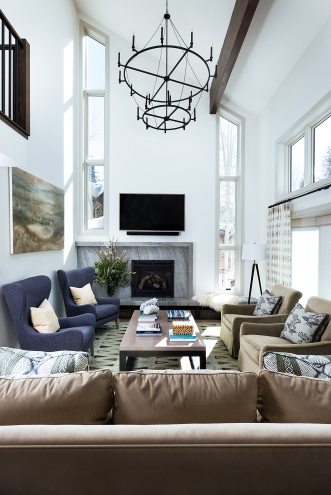 Inspiration for a large traditional living room in Denver with white walls, a stone fireplace surround, a wall mounted tv, exposed beams, a vaulted ceiling, medium hardwood flooring, a standard fireplace and brown floors.