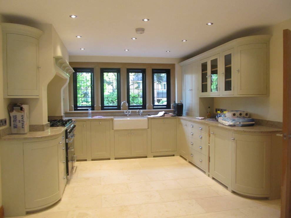 Design ideas for an arts and crafts u-shaped open plan kitchen in Cheshire with a farmhouse sink, shaker cabinets, green cabinets, granite benchtops, panelled appliances, marble floors and no island.