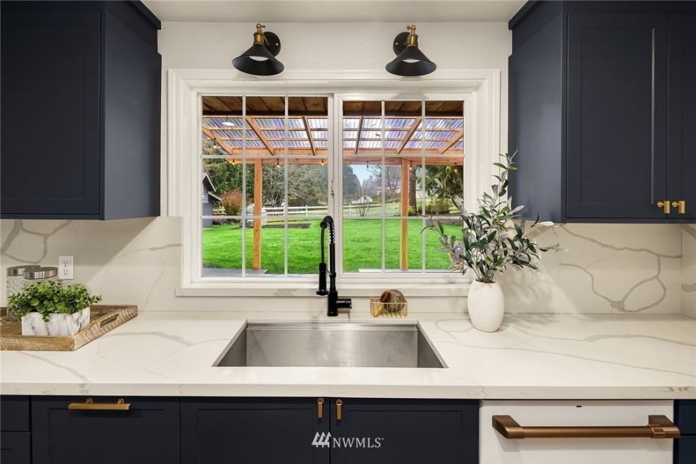 Design ideas for a mid-sized midcentury galley kitchen in Seattle with a drop-in sink, shaker cabinets, blue cabinets, quartzite benchtops, white splashback, white appliances and blue benchtop.