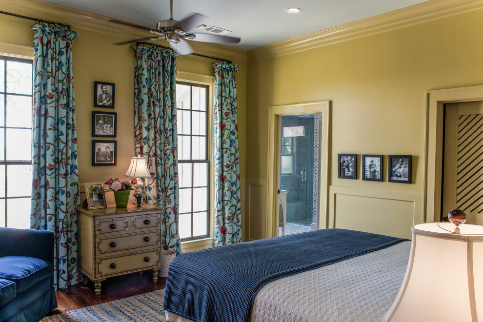 Design ideas for a country guest bedroom in Other with dark hardwood floors, brown floor, decorative wall panelling and yellow walls.