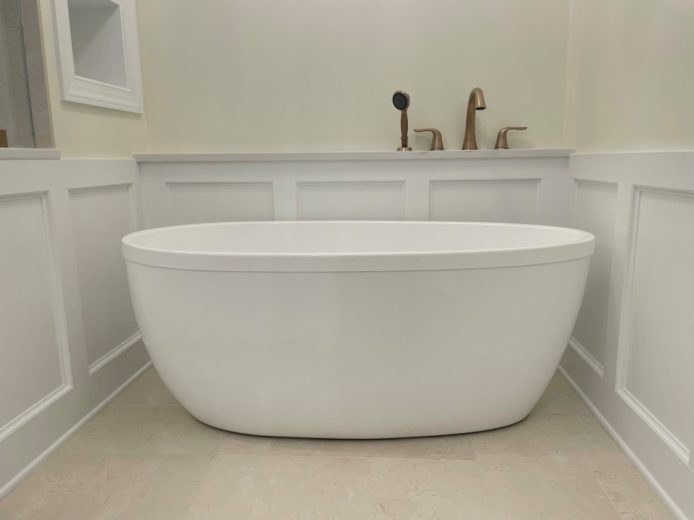 Photo of a large modern master bathroom in DC Metro with a freestanding tub, beige walls, travertine floors, beige floor, white tile, wood-look tile and decorative wall panelling.