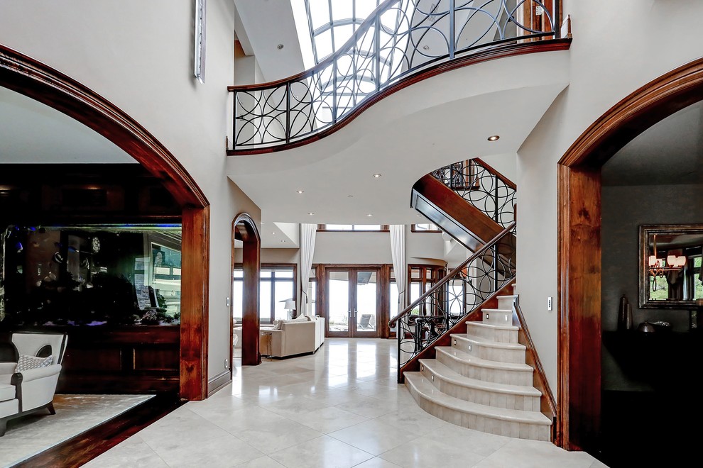 Example of a transitional porcelain tile foyer design in Toronto with gray walls and a medium wood front door