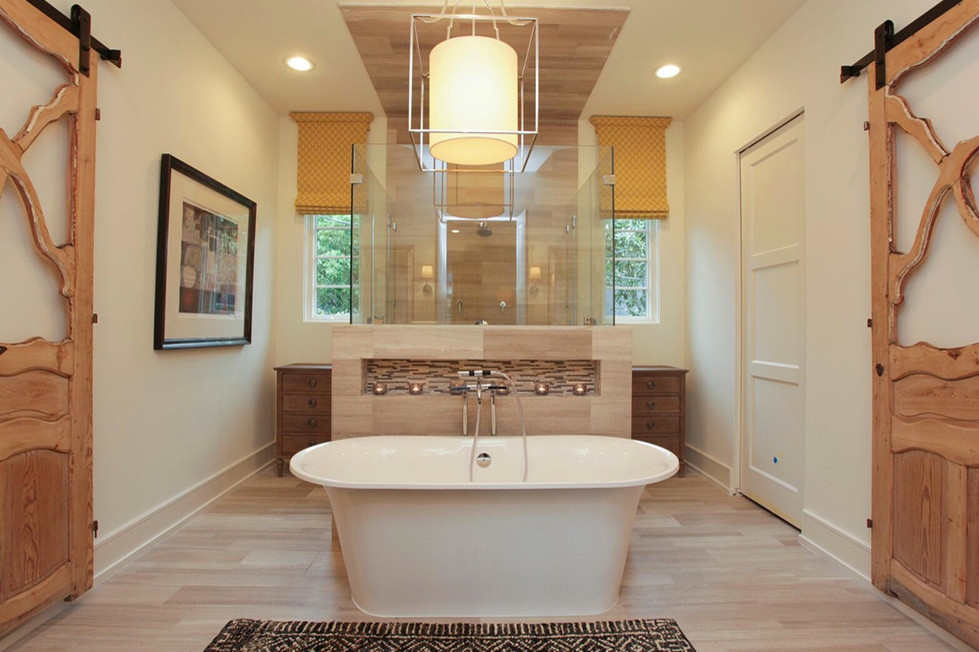 This is an example of a large arts and crafts master bathroom in Houston with flat-panel cabinets, dark wood cabinets, a freestanding tub, an open shower, beige tile, porcelain tile, white walls and porcelain floors.