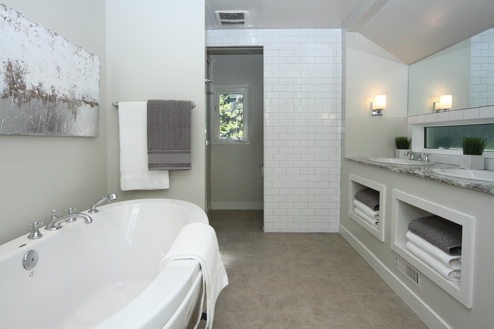 Inspiration for a large transitional master white tile ceramic tile freestanding bathtub remodel in Calgary with a drop-in sink, granite countertops and white walls