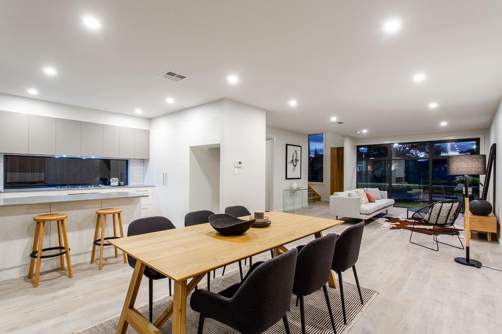 This is an example of a contemporary open concept living room in Adelaide with white walls.