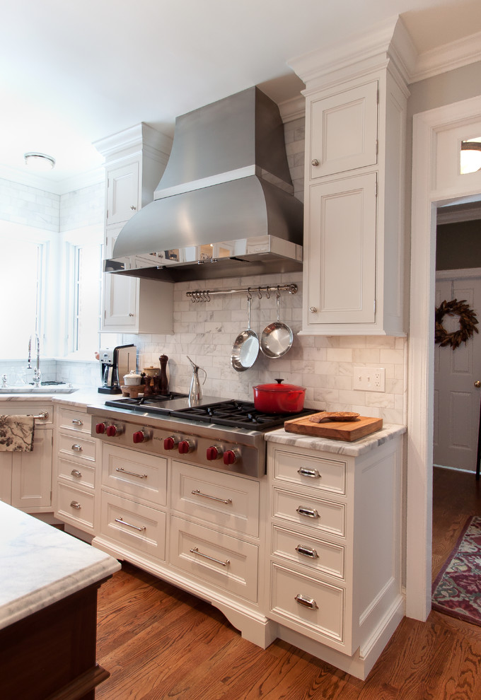 Example of a large transitional kitchen design in DC Metro with beaded inset cabinets, white cabinets, marble countertops, white backsplash, subway tile backsplash, stainless steel appliances and an island
