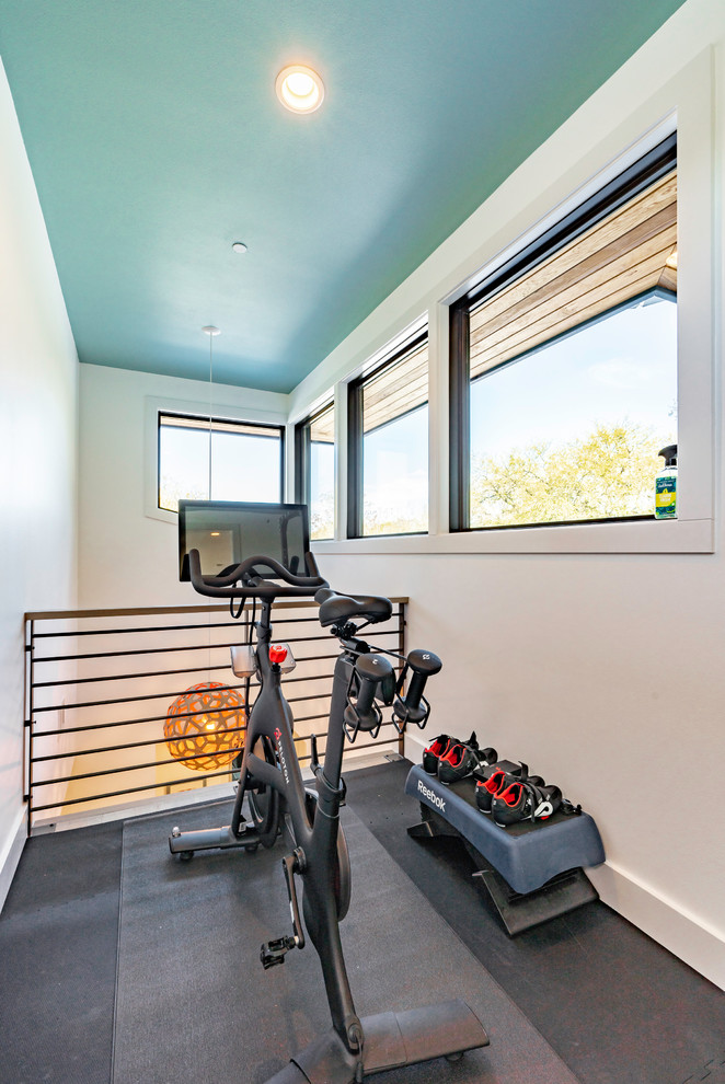 Design ideas for a large contemporary home gym in Austin with white walls and grey floor.
