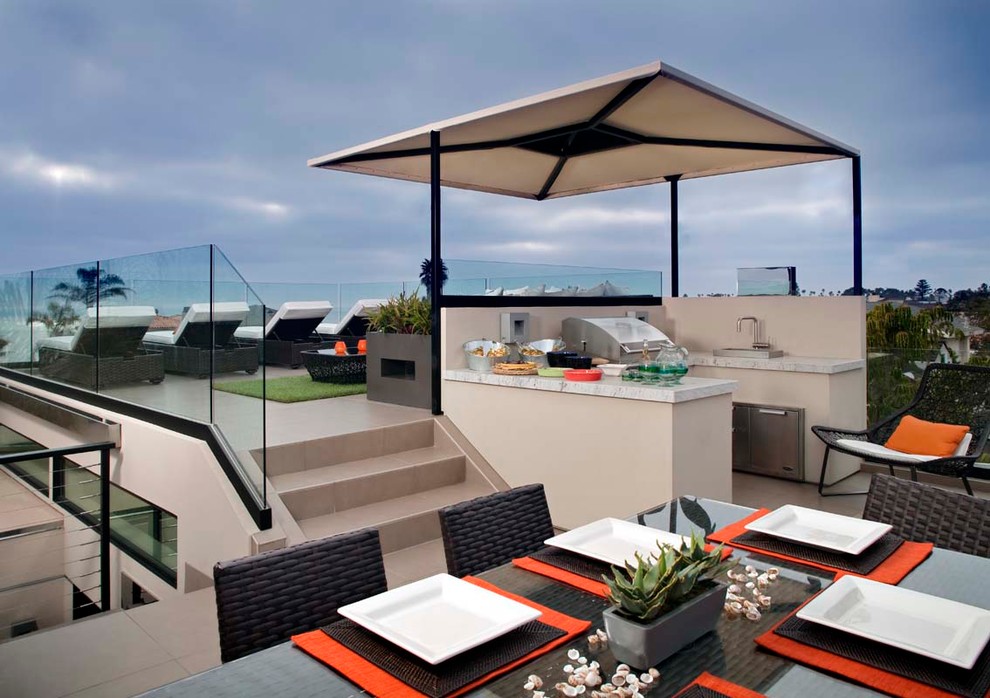 Large modern rooftop deck in San Diego with an outdoor kitchen and an awning.