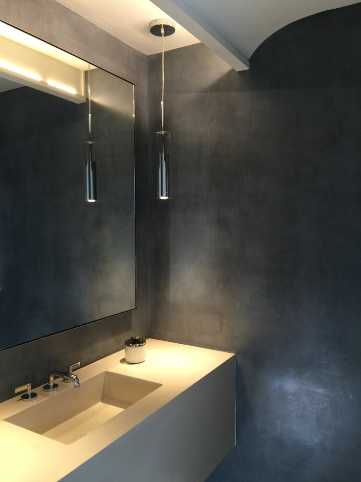 Mid-sized contemporary 3/4 bathroom in New York with flat-panel cabinets, grey walls and an integrated sink.