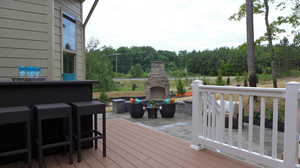 Huge transitional backyard deck photo in Richmond with a fireplace and no cover
