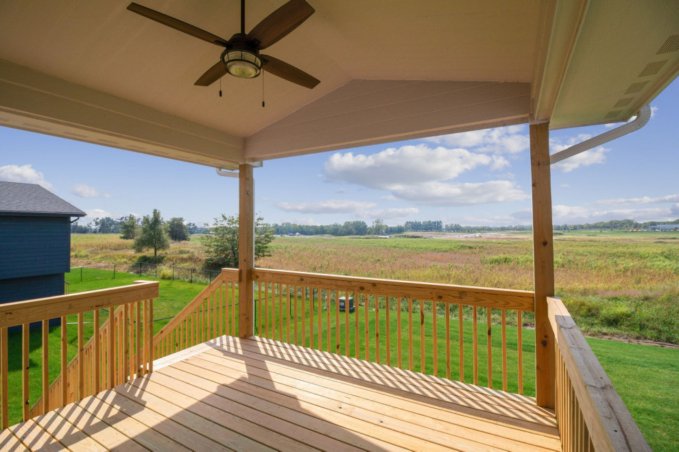 Deck - mid-sized modern backyard deck idea with a roof extension