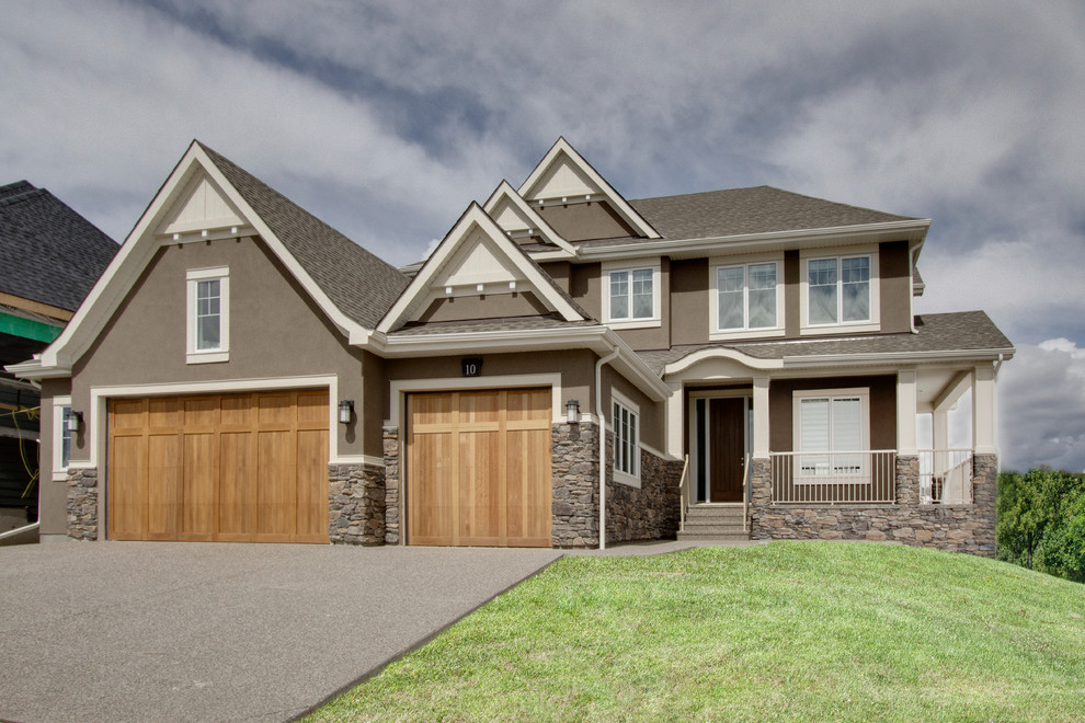 Inspiration for a large transitional two-storey brown exterior in Calgary with mixed siding and a gable roof.