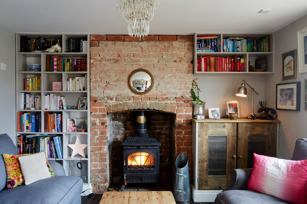 Design ideas for a small eclectic living room in Wiltshire with a library and a wood stove.