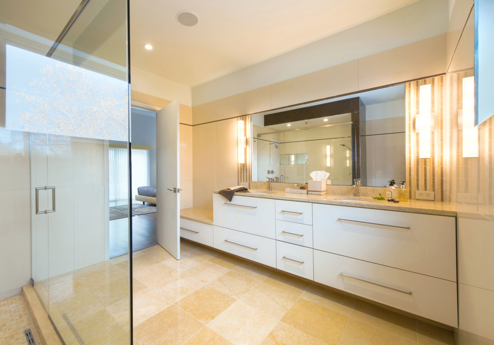 Photo of a large contemporary master bathroom in DC Metro with flat-panel cabinets, beige cabinets, a double shower, a one-piece toilet, beige tile, porcelain tile, limestone floors, an undermount sink, solid surface benchtops, yellow floor, a hinged shower door, yellow benchtops, a double vanity and a built-in vanity.