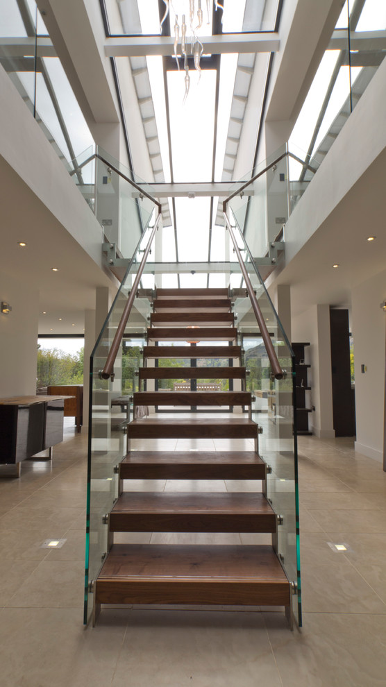 Contemporary wood straight staircase in London with open risers.