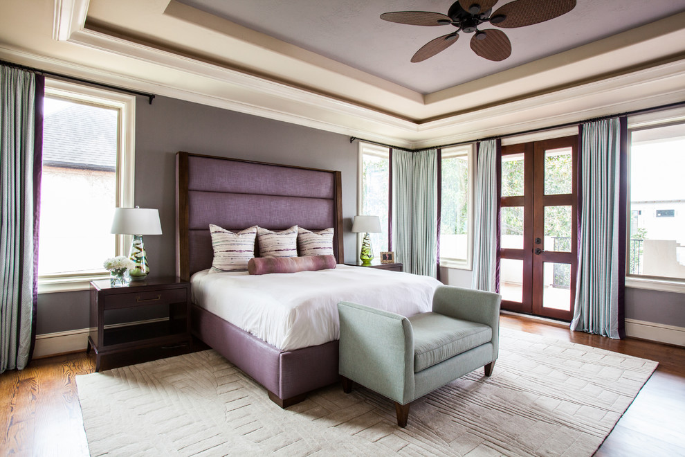 Inspiration for a large transitional master bedroom in Houston with grey walls and dark hardwood floors.