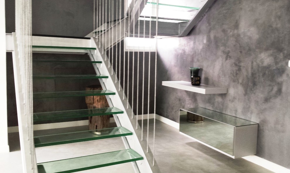 Inspiration for a large contemporary glass straight staircase in Other with metal risers.