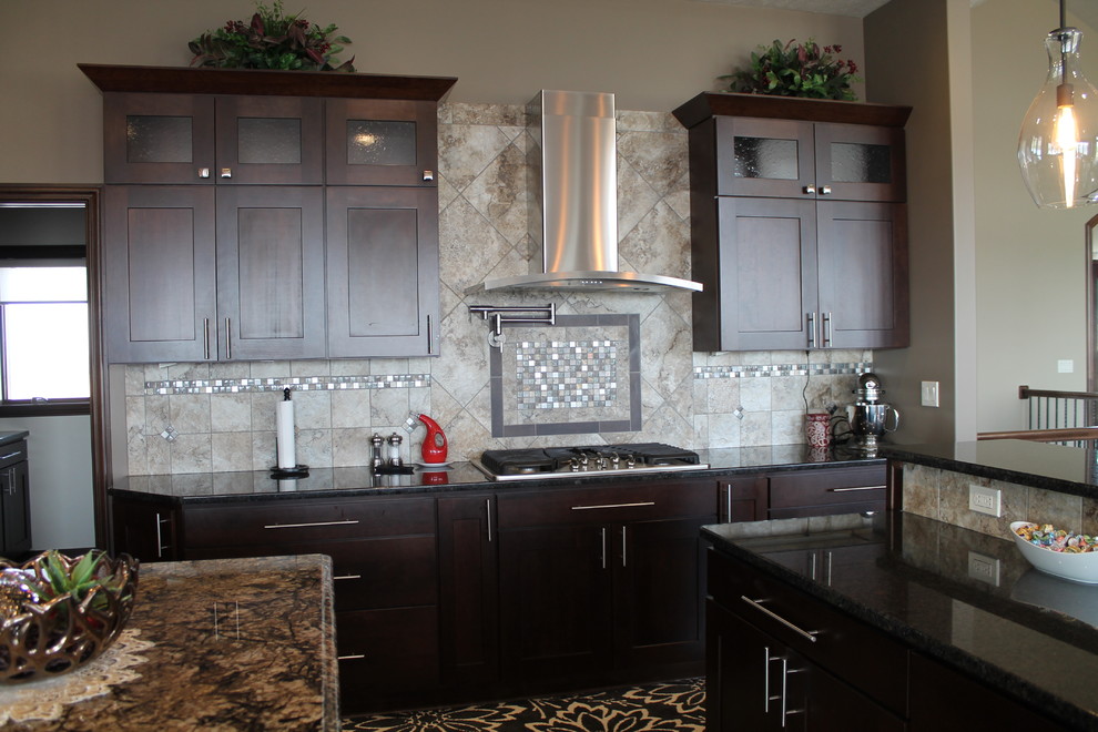 Open concept kitchen - large single-wall dark wood floor open concept kitchen idea with an undermount sink, flat-panel cabinets, dark wood cabinets, granite countertops, beige backsplash, stainless steel appliances, beige walls and two islands