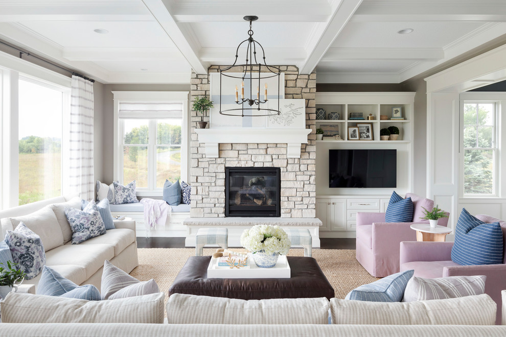 Photo of a beach style family room in Minneapolis with grey walls, dark hardwood floors, a standard fireplace, a stone fireplace surround and a built-in media wall.