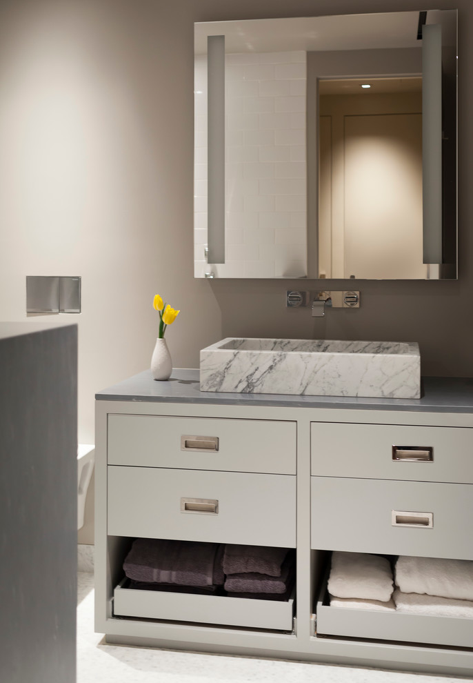 This is an example of a large contemporary kids bathroom in San Francisco with flat-panel cabinets, white cabinets, gray tile, an integrated sink and marble benchtops.