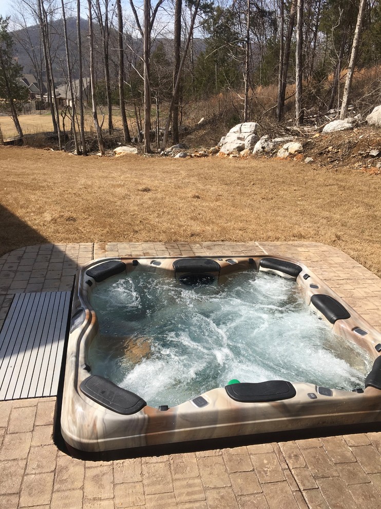 Hot tub - mid-sized transitional backyard stamped concrete and rectangular hot tub idea