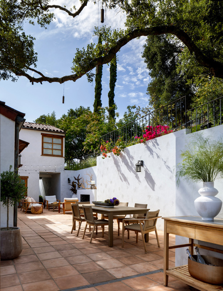 Example of a large tuscan backyard concrete paver patio design in San Francisco