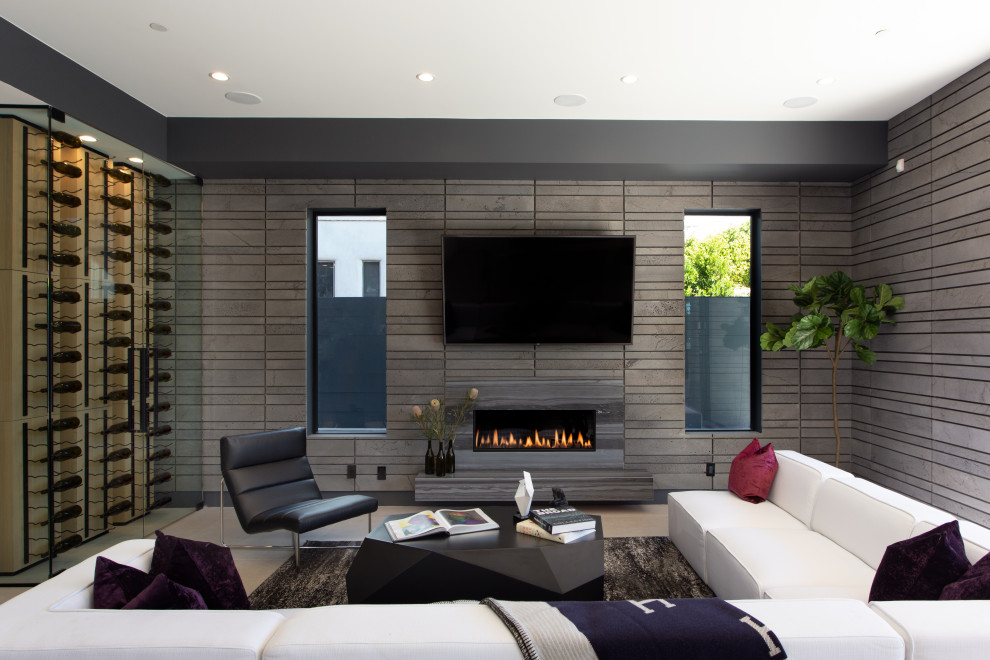 This is an example of a large contemporary living room in Los Angeles with grey walls, a ribbon fireplace, a tile fireplace surround, a wall-mounted tv and beige floor.